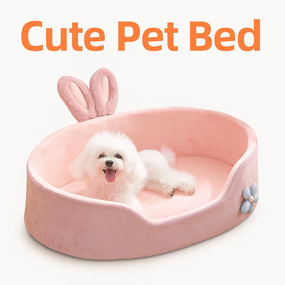 Pink bunny-eared pet bed with a happy small white dog, flower design on the side, light background