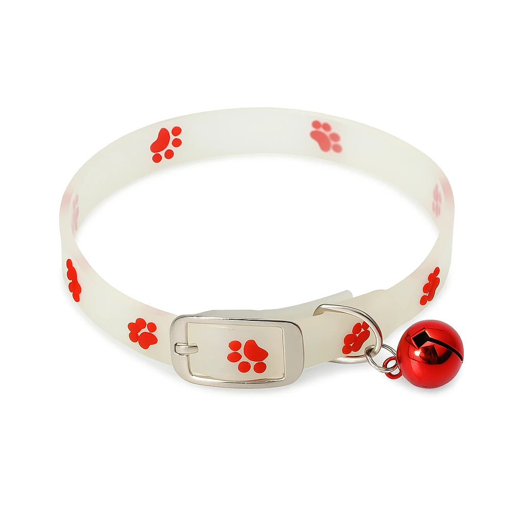 White silicone pet collar with red paw print design and attached red bell, isolated on white background