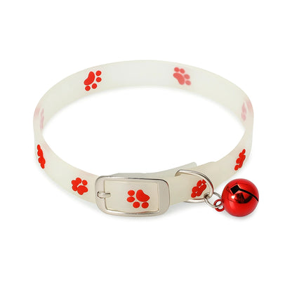 White silicone pet collar with red paw print design and attached red bell, isolated on white background